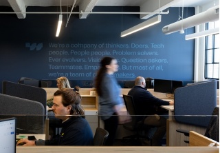 Modern open office with employees working walker xm headquarters