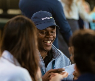 Smiling team member wearing walker xm cap discussing customer experience