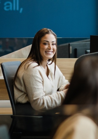 Smiling walker xm team member at desk