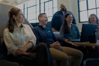 Walker xm colleagues laughing in conference room