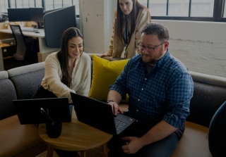 Walker xm team reviewing qualtrics implementation on laptop